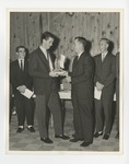 A photo of a male student accepting an award from a man by Lonnie W. Fleming Sr.