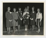 A photo of six girls and a man crowning the blonde girl by Lonnie W. Fleming Sr.