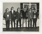 A photo of six young men standing with trophies by Lonnie W. Fleming Sr.