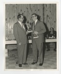 A photo of two gentlemen in suits holding rewards by Lonnie W. Fleming Sr.