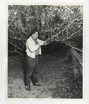 A photo of a man cutting a branching off a tree with a saw by Lonnie W. Fleming Sr.