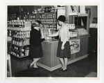 Two girls looking a different color shades in a paint store by Lonnie W. Fleming Sr.