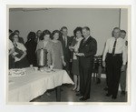 A photo of a group of people around a table with coffee and cake on it by Lonnie W. Fleming Sr.