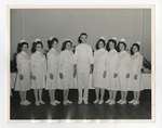 Female nurses on either side with a male nurse in the middle by Lonnie W. Fleming Sr.