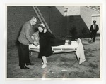 Man instructing woman on how to carry another woman out of stretcher by Lonnie W. Fleming Sr.