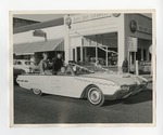 2 women sitting atop a white convertible car by Lonnie W. Fleming Sr.