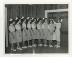 Similar to 536 and 535, but elder nurse is putting nursing hat on one of the young nurses by Lonnie W. Fleming Sr.
