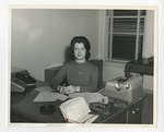 Woman from 539, but sitting at desk with hands folded by Lonnie W. Fleming Sr.