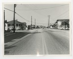 A road with small stores on either side by Lonnie W. Fleming Sr.