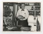 Gentleman holding meat in a Butcher shop by Lonnie W. Fleming Sr.