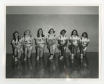 An integrated female basketball team kneeling for a team picture by Lonnie W. Fleming Sr.