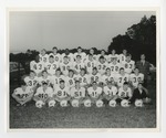 A team photo of the Conway football team with a gentleman in a plaid jacket on the right by Lonnie W. Fleming Sr.