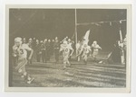 A football team running through the mascot banner by Lonnie W. Fleming Sr.