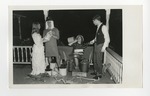 Four kids messing with alcohol bottle props on a front porch deck by Lonnie W. Fleming Sr.
