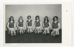 Six cheerleaders sitting on their knees by Lonnie W. Fleming Sr.