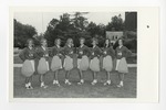 Eight cheerleaders standing on a lawn for a group picture by Lonnie W. Fleming Sr.