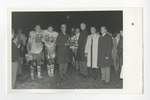 Two men in coats holding a football trophy by Lonnie W. Fleming Sr.