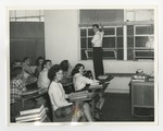 Students in their desks in a classroom by Lonnie W. Fleming Sr.