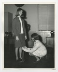 A girl having the length of her skirt measured by another girl by Lonnie W. Fleming Sr.