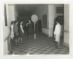 A woman holding a stop sign in the halls of a school by Lonnie W. Fleming Sr.