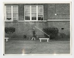 A girl walking along the side of Conway High school by Lonnie W. Fleming Sr.