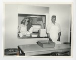 Three men in a cafeteria kitchen by Lonnie W. Fleming Sr.