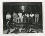 A group of basketball players kneeling by Lonnie W. Fleming Sr.