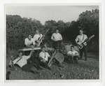 A jazz band taking a group picture, with the front row sitting by Lonnie W. Fleming Sr.
