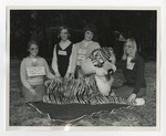 Four girls with black eyes posing by a plush tiger by Lonnie W. Fleming Sr.