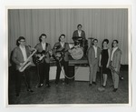 A school Jazz band (the Customs) taking a group picture in front of curtains by Lonnie W. Fleming Sr.