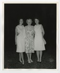Three women taking a photo together on the grass by Lonnie W. Fleming Sr.