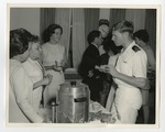 An military officer talking to women at a refreshment table by Lonnie W. Fleming Sr.