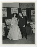 Miss South Carolina next to suited gentleman with displays behind them by Lonnie W. Fleming Sr.