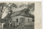 Firemen and observers looking at a house on fire by Lonnie W. Fleming Sr.