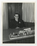 Conway Fire Chief at his desk with model trucks on it by Lonnie W. Fleming Sr.