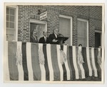 A man speaking on a stage podium in front of the department of public welfare by Lonnie W. Fleming Sr.