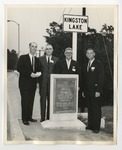 Four gentlemen standing behind a statued plaque that says "The Kingston Lake Bridge" by Lonnie W. Fleming Sr.