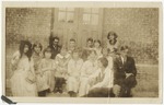 Students sitting on stairs in front of school doors. by Horry County Historical Society